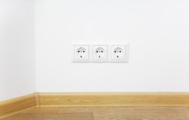 Empty interior white wall with power outlet / wooden floor clipart