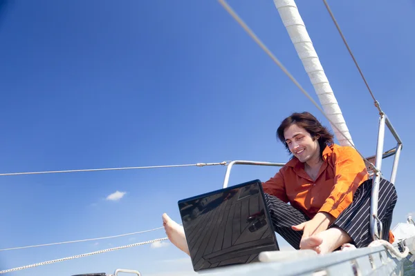 Businessman with laptop on sailboat — Stock Photo, Image