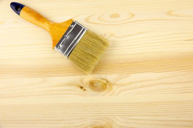 Wood and paintbrush / covering by varnish clipart