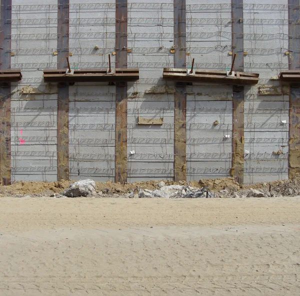 Concrete wall and sand road on a large construction site — Stock Photo ...