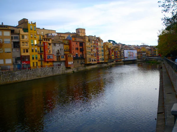 stock image Colorful houses on the river bank and its reflection in water