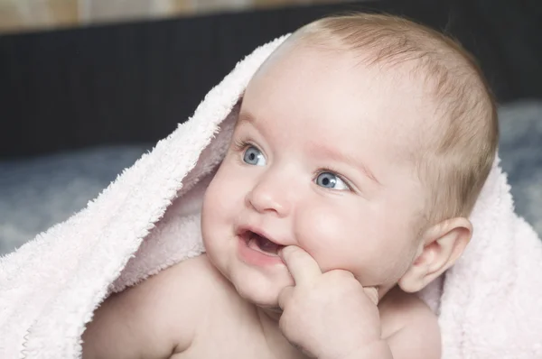 Smiling baby with a towel — Stock Photo, Image