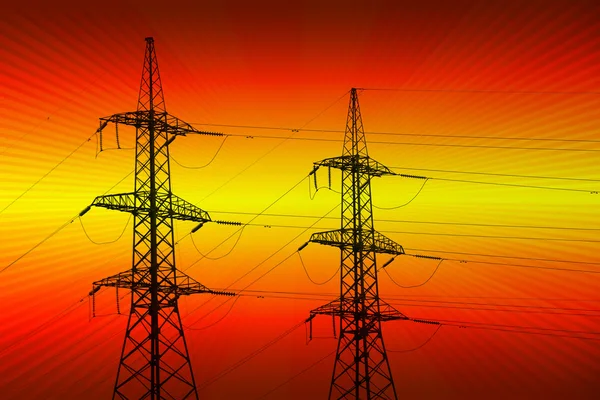 Electric power transmission towers at sunset — Stock Photo, Image