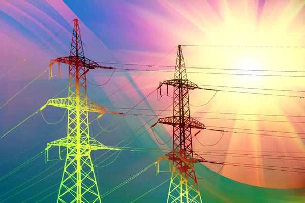Elektrische transmissie torens bij zonsondergang Stockfoto