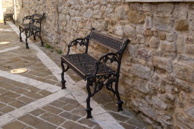 Metal weaving benches ancient walls Italian clipart