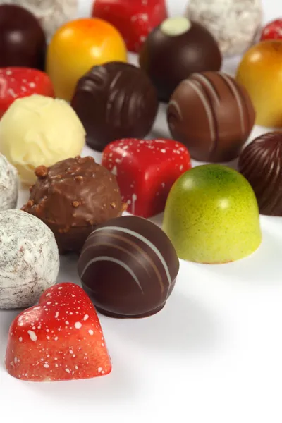 Chocolates surtidos en blanco —  Fotos de Stock