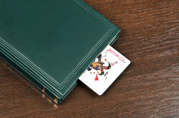 Book and joker card — Stock Photo, Image