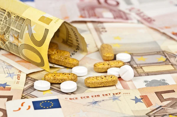 Pénz és a tabletták — Stock Fotó