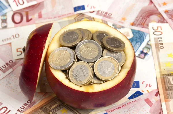 Coins on apple — Stock Photo, Image
