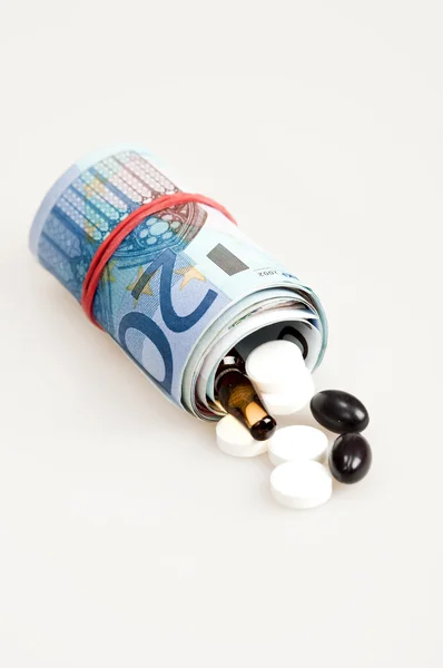 Soldi e pillole — Foto Stock