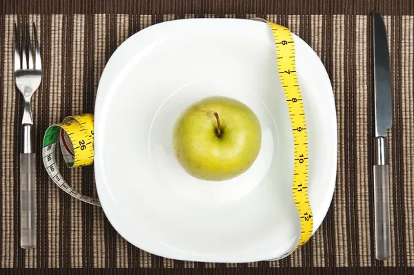 Яблоко на тарелке — стоковое фото