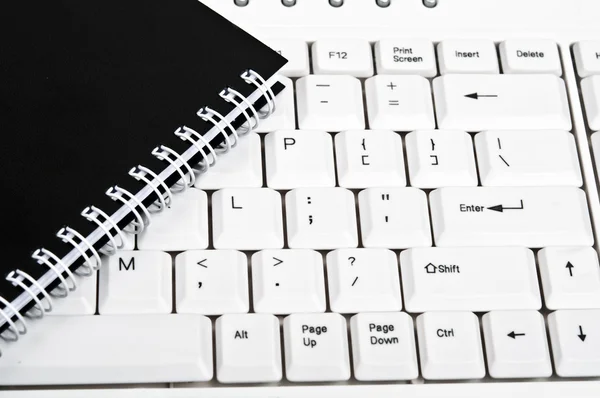 Notebook on keyboard — Stock Photo, Image