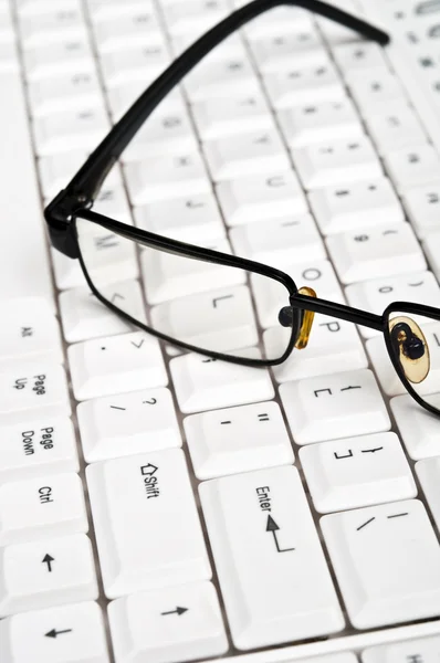 stock image Eye glasses on keyboard