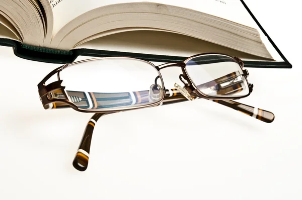 Book and eyeglasses Stock Image