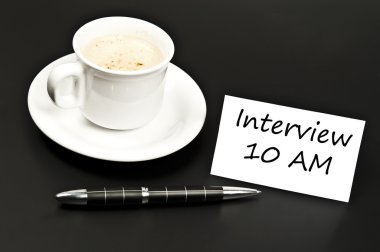 Interview message on desk with coffee clipart