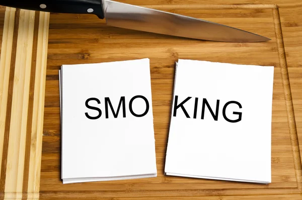 Knife cut paper with smoking — Stock Photo, Image