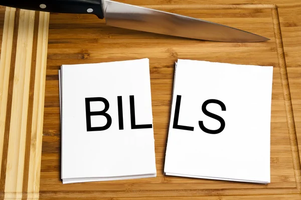 Knife cut paper with bills — Stock Photo, Image