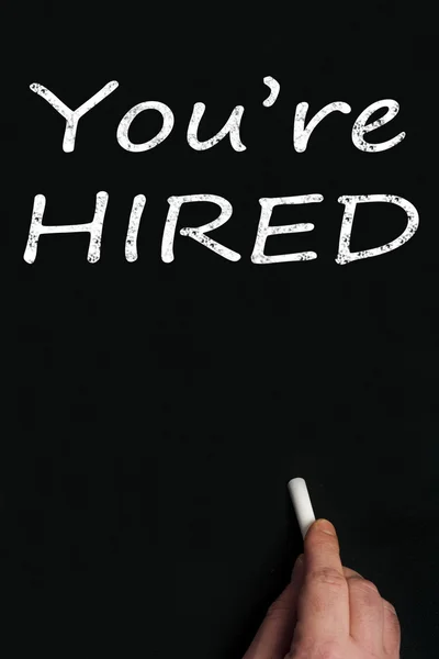 You're hired on black board — Stock Photo, Image