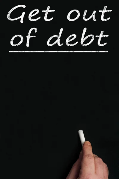 Get out of debt on black board — Stock Photo, Image