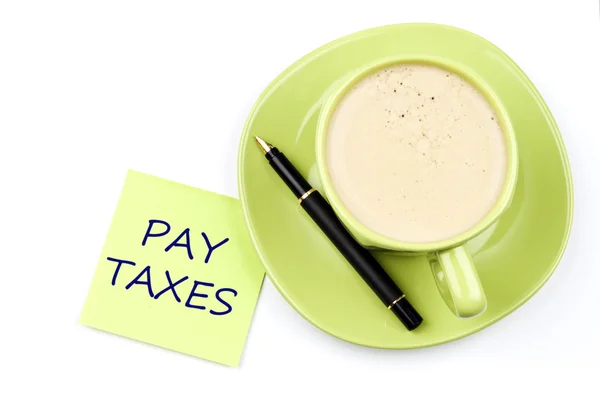 Pay taxes note and coffee — Stock Photo, Image