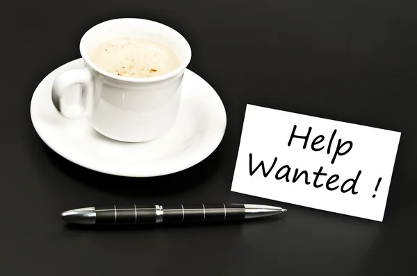 Help wanted noted on desk with coffee — Stock Photo, Image