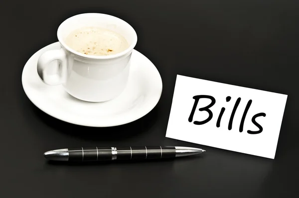 Bills noted on desk with coffee — Stock Photo, Image