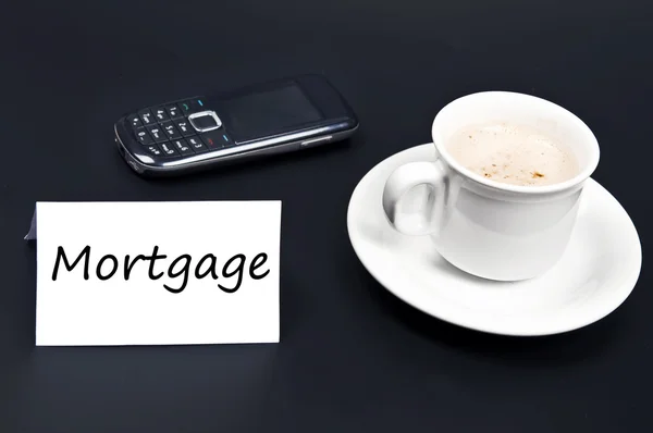Mortgage message on desk with coffee — Stock Photo, Image