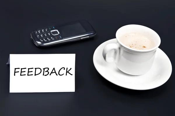 Feedback noted on desk with coffee — Stock Photo, Image