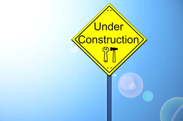 Under construction on road sign — Stock Photo, Image