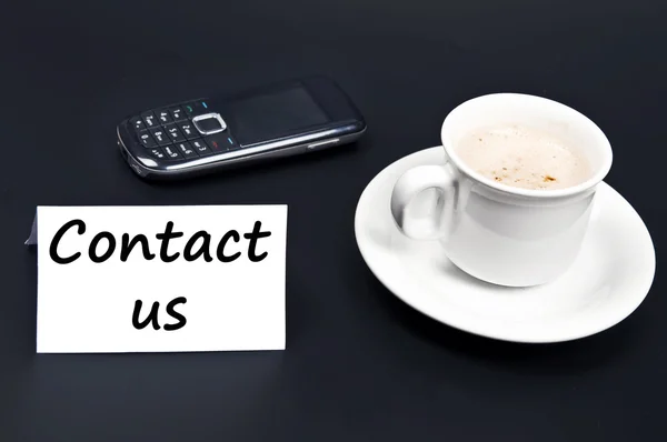 Contact us noted on desk with coffee — Stock Photo, Image