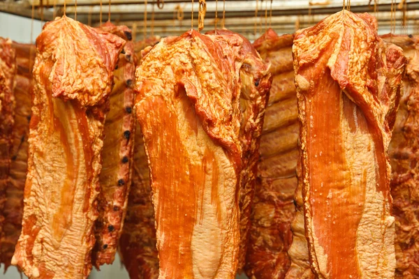 Stock image Hanging smoked pork ribs