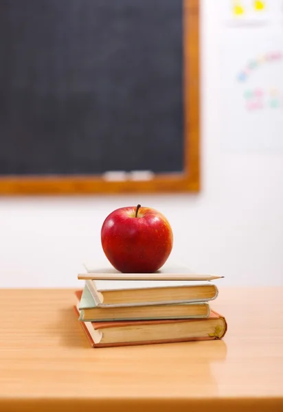 Red apple on books in class room — Stock Photo, Image