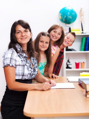 Cheerful teacher and several students clipart