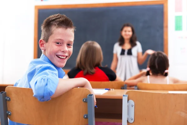 Fröhlicher Junge im Klassenzimmer — Stockfoto