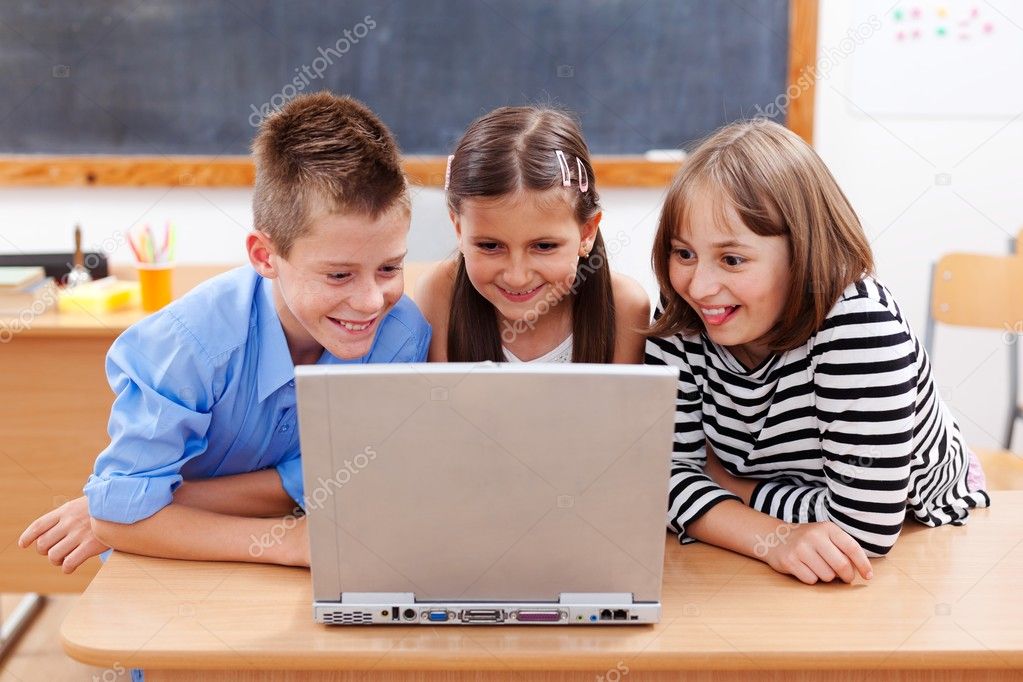Happy kids looking at laptop