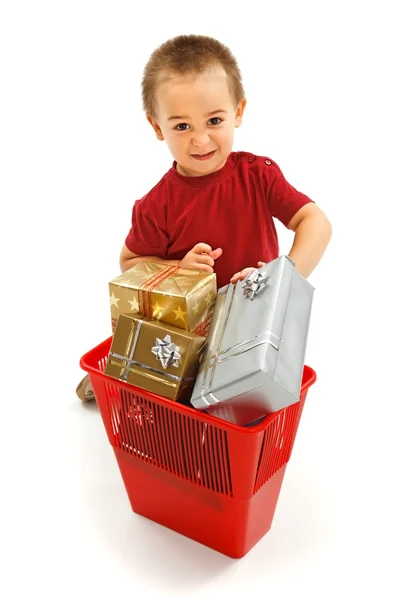 Little boy throwing presents in garbage bin — Stock Photo, Image