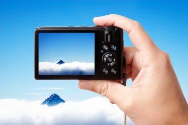 Tourist's hand holding photo camera clipart