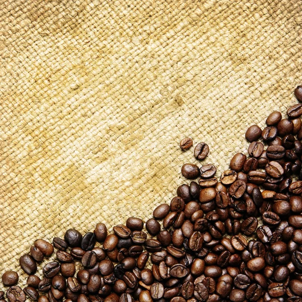 stock image Coffee beans on traditional sack textile