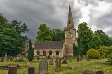 St Mary's Church with graveyard in Cotswolds, Lower Slaughter, UK clipart