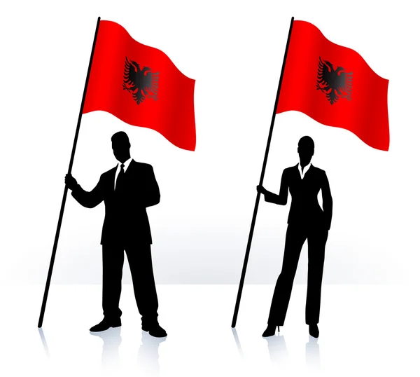 Business silhouettes with waving flag of Albania — Stock Vector