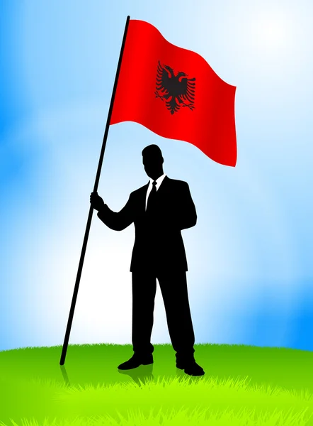 Homme d'affaires Leader tenant le drapeau de l'Albanie — Image vectorielle
