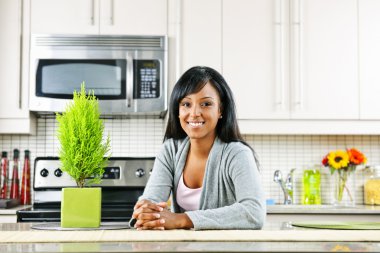 Young woman in kitchen clipart