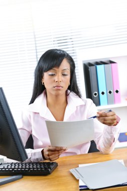 Black businesswoman working at desk clipart