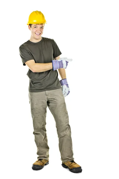 Smiling construction worker pointing to the side — Stock Photo, Image