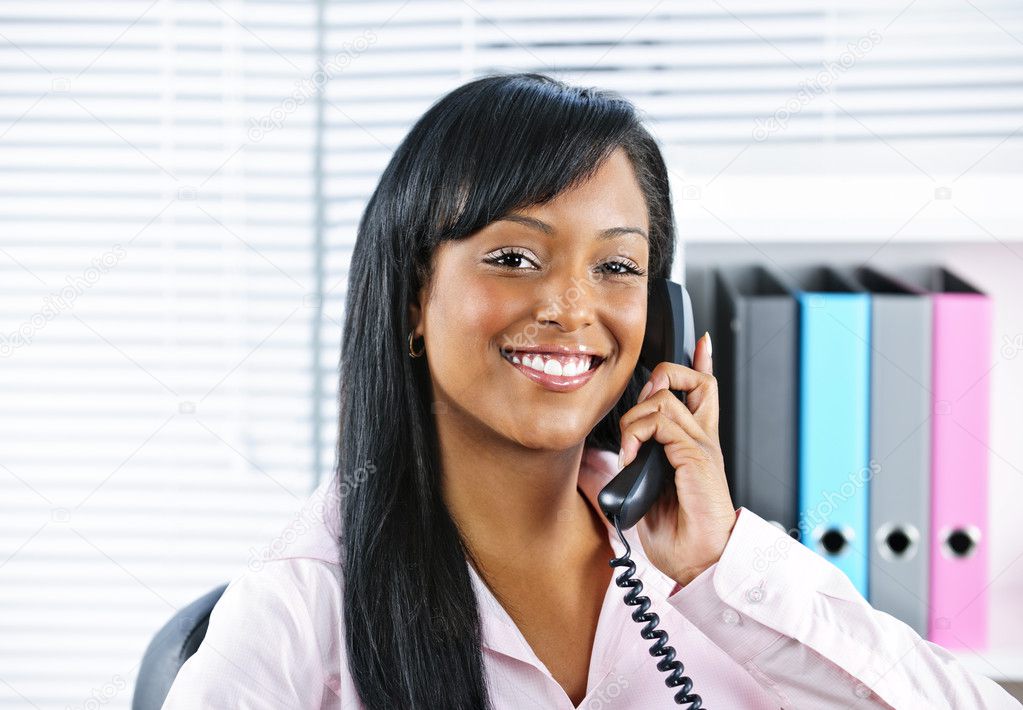 Young black businesswoman talking on phone