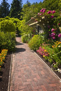 Flower garden with paved path clipart