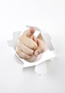 Finger pointing through hole in paper clipart