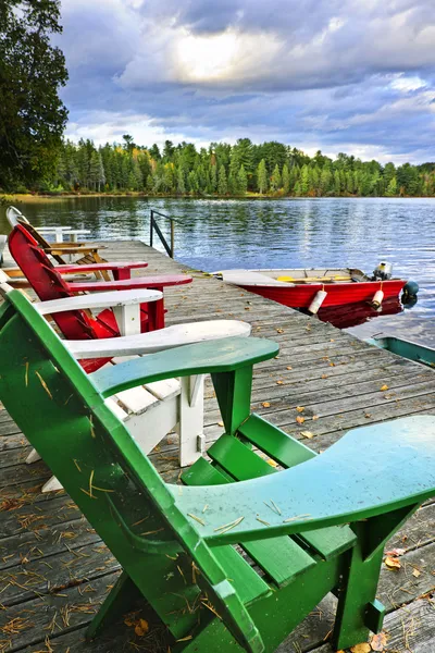 Deck chairs on dock at lake — Stock Photo, Image