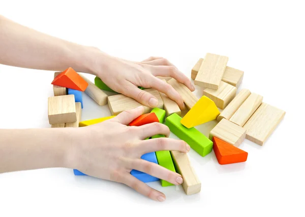 Mains avec des jouets en bois — Photo