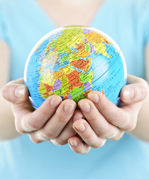 Globe of the planet Earth held in young female hands